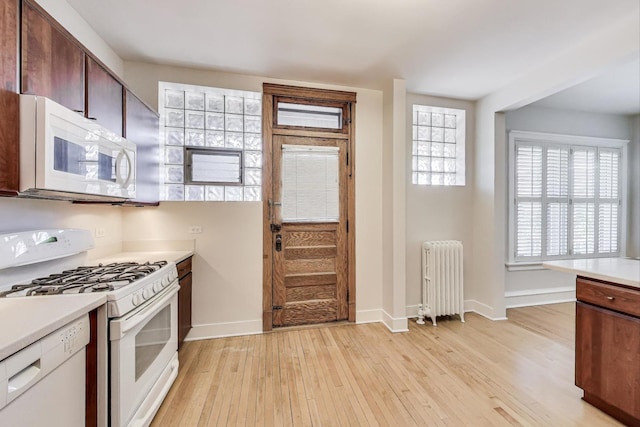 1431 W Rascher Ave Unit 1W, Chicago, IL 60640 - kitchen featuring radiator heating unit, white appliances, baseboards, and light wood-style floors