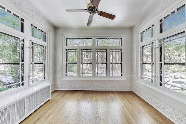 1431 W Rascher Ave Unit 1W, Chicago, IL 60640 - unfurnished sunroom featuring radiator, healthy amount of natural light, hardwood / wood-style flooring, and baseboards