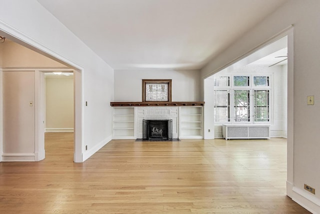 1431 W Rascher Ave Unit 1W, Chicago, IL 60640 - unfurnished living room featuring radiator, light wood-type flooring, a brick fireplace, and baseboards