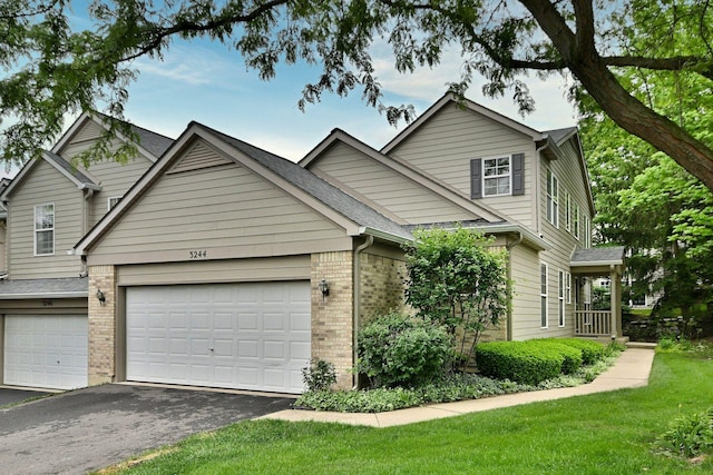 3244 Foxridge Ct, Woodridge, IL 60517 - traditional home with brick siding, asphalt driveway, a front yard, and a garage