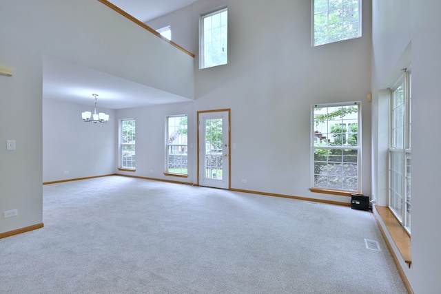 3244 Foxridge Ct, Woodridge, IL 60517 - unfurnished living room with a chandelier, baseboards, carpet floors, and a towering ceiling