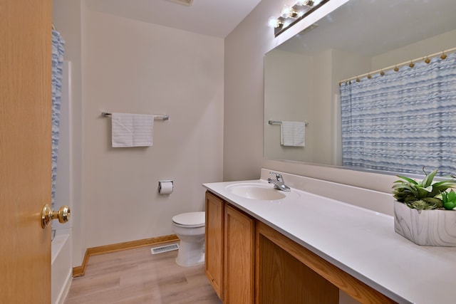 3244 Foxridge Ct, Woodridge, IL 60517 - full bathroom with wood finished floors, vanity, toilet, and baseboards