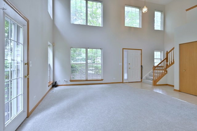 3244 Foxridge Ct, Woodridge, IL 60517 - unfurnished living room featuring a high ceiling, light carpet, stairway, and plenty of natural light