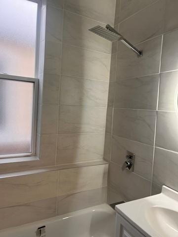full bath featuring vanity, shower / tub combination, and a wealth of natural light