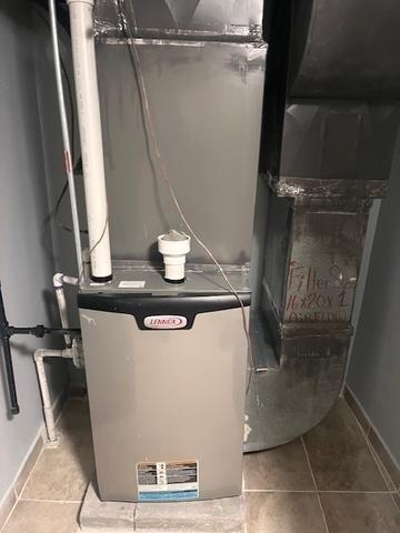 utility room featuring heating unit