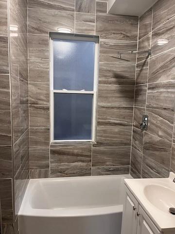 full bathroom with vanity and bathing tub / shower combination