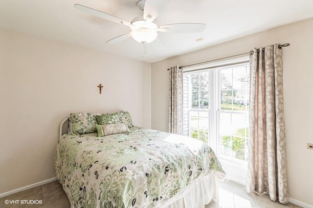 bedroom with baseboards, light carpet, and a ceiling fan