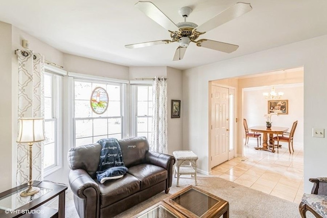 living area featuring light tile patterned floors, baseboards, and a wealth of natural light