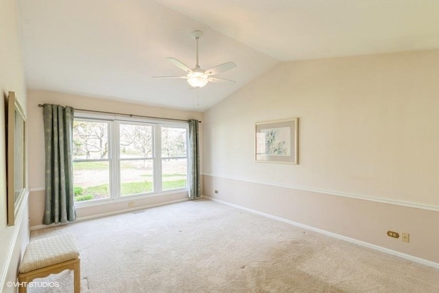unfurnished room featuring baseboards, a ceiling fan, carpet flooring, and lofted ceiling