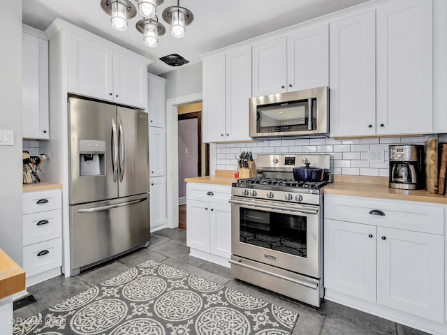 303 Anthony St, Glen Ellyn, IL 60137 - kitchen featuring appliances with stainless steel finishes, wood counters, tasteful backsplash, white cabinetry, and light tile patterned floors