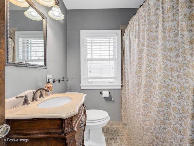 303 Anthony St, Glen Ellyn, IL 60137 - full bathroom with healthy amount of natural light, toilet, vanity, and tile patterned floors