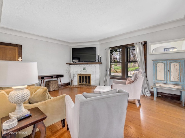 303 Anthony St, Glen Ellyn, IL 60137 - living room with a brick fireplace, a textured ceiling, and light wood-style floors