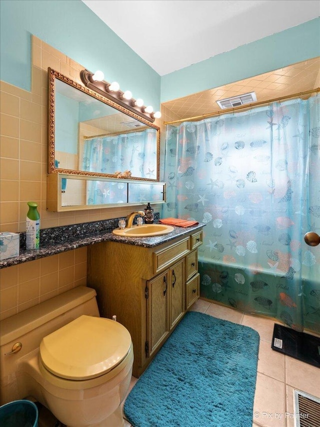 full bath with shower / tub combo with curtain, toilet, tile patterned floors, tile walls, and visible vents