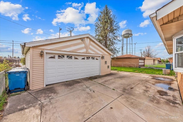 detached garage featuring fence