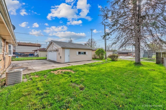 view of yard with an outbuilding, a garage, central AC, fence, and a patio