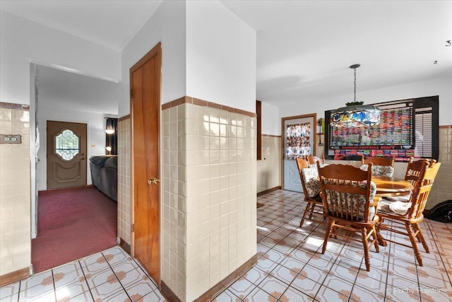 dining space with tile walls