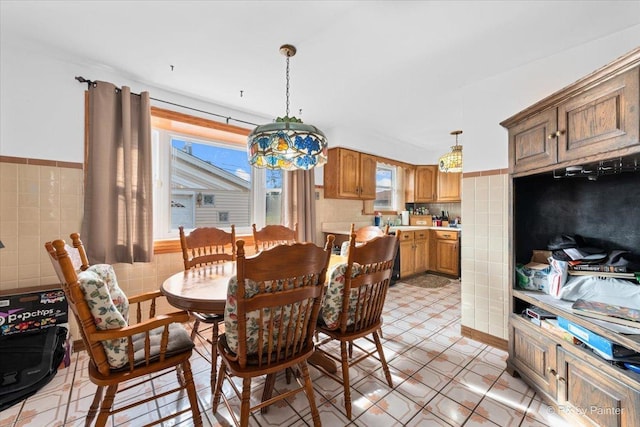 dining space featuring tile walls