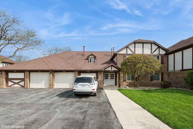 tudor house with a front lawn and driveway