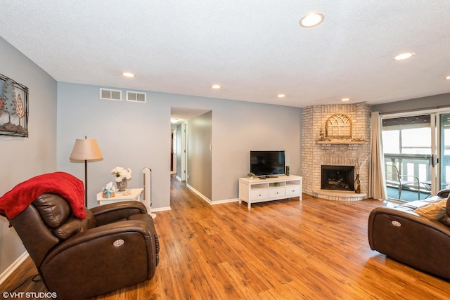 living room featuring visible vents, wood finished floors, and recessed lighting