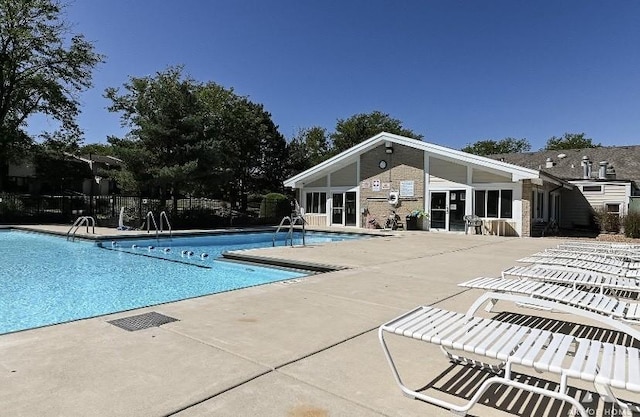 pool featuring a patio area and fence
