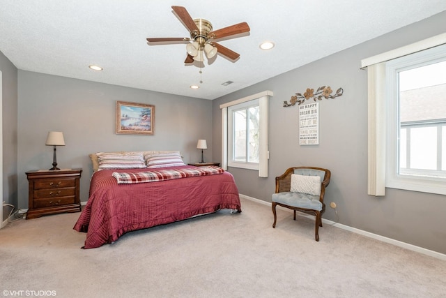 carpeted bedroom with recessed lighting, baseboards, visible vents, and multiple windows