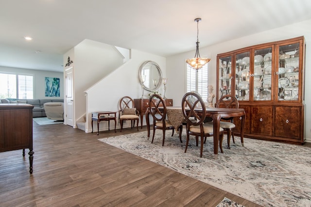 dining room featuring stairs, baseboards, dark wood-style floors, a chandelier, and recessed lighting
