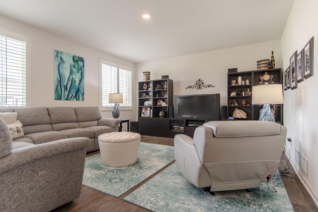 living room featuring visible vents and wood finished floors
