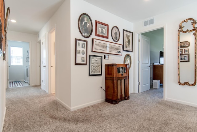 corridor with baseboards, carpet flooring, and visible vents