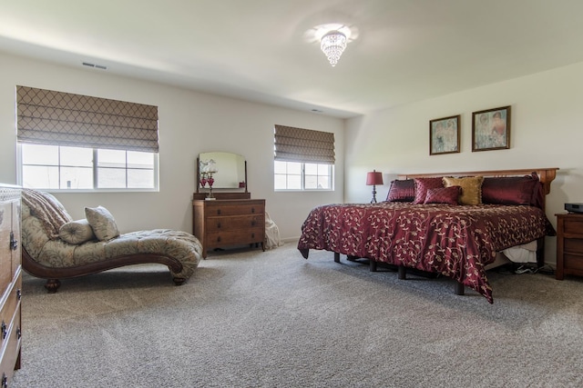 bedroom with visible vents and carpet