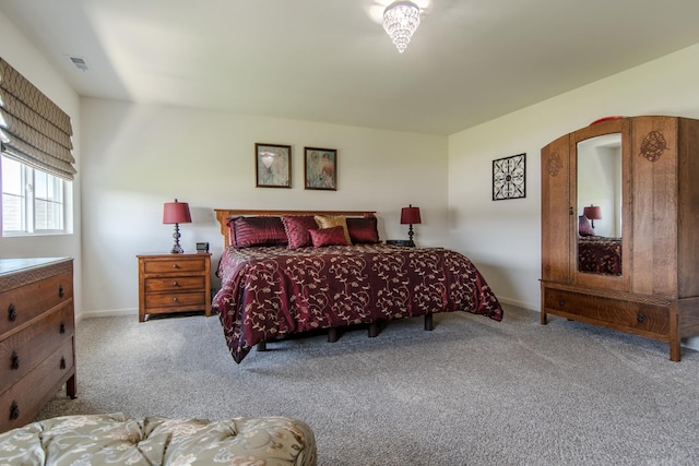 carpeted bedroom featuring visible vents and baseboards