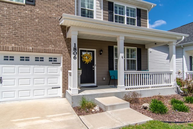 property entrance featuring brick siding, covered porch, and concrete driveway