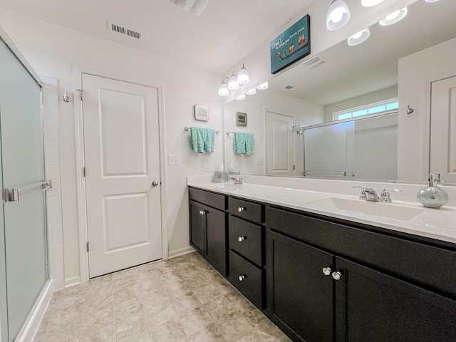 full bathroom with double vanity, visible vents, a shower stall, a sink, and baseboards