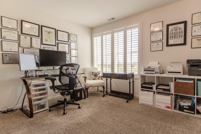office area featuring visible vents, carpet, and baseboards