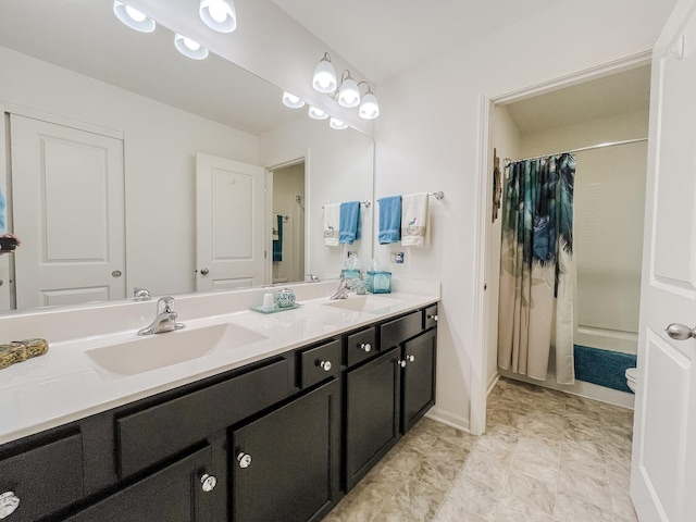 bathroom with a shower with shower curtain, double vanity, baseboards, and a sink