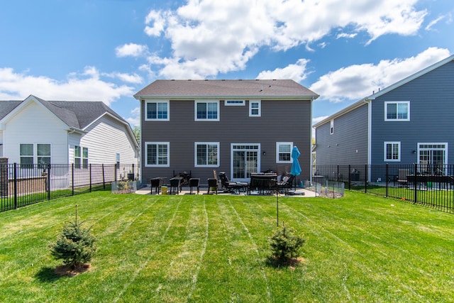 back of property featuring a yard, a fenced backyard, and a patio area