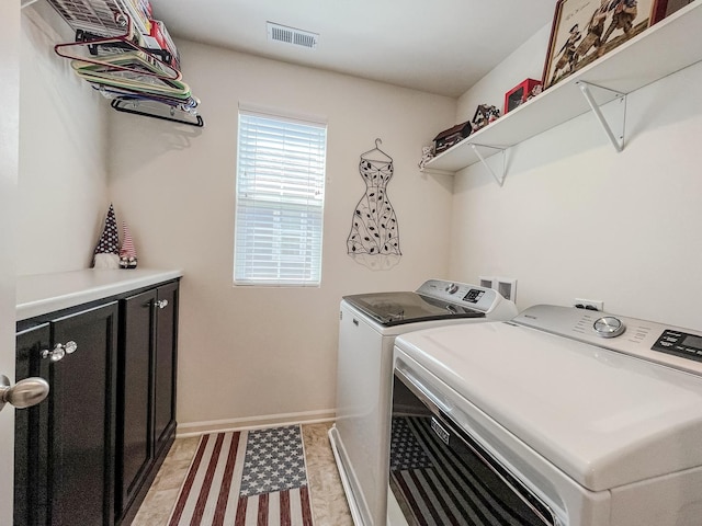 clothes washing area featuring baseboards, washing machine and dryer, cabinet space, and visible vents