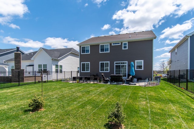 rear view of house with a patio, a fenced backyard, and a lawn