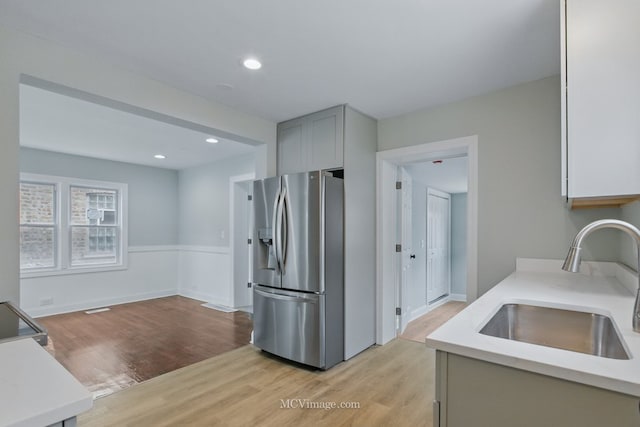 8907 S Luella Ave, Chicago, IL 60617 - kitchen featuring stainless steel fridge, a sink, light wood finished floors, gray cabinets, and recessed lighting