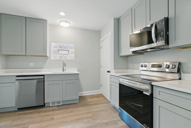 8907 S Luella Ave, Chicago, IL 60617 - kitchen with appliances with stainless steel finishes, a sink, gray cabinetry, light countertops, and recessed lighting