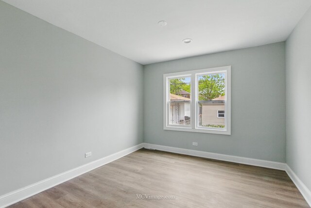 8907 S Luella Ave, Chicago, IL 60617 - empty room featuring light wood-style floors and baseboards