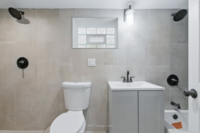 8907 S Luella Ave, Chicago, IL 60617 - full bathroom with toilet, shower / tub combination, vanity, and tile walls
