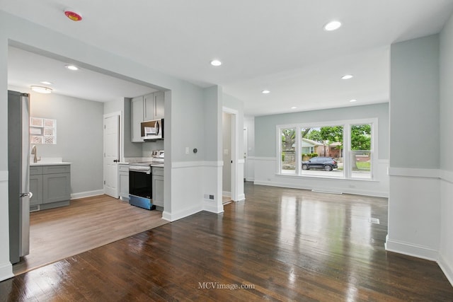 8907 S Luella Ave, Chicago, IL 60617 - unfurnished living room with dark wood-style flooring, a sink, recessed lighting, and baseboards