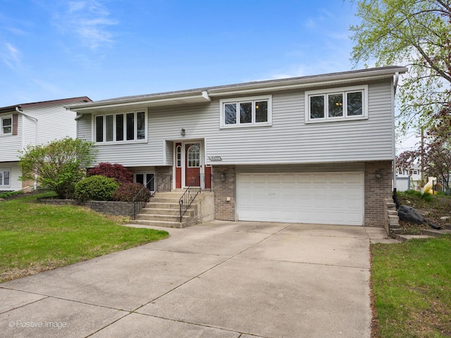 8920 Sycamore Dr, Hickory Hills, IL 60457 - bi-level home featuring brick siding, a garage, driveway, and a front yard