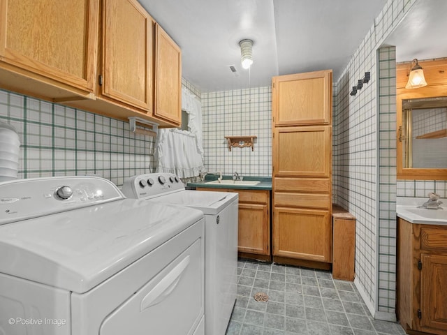 8920 Sycamore Dr, Hickory Hills, IL 60457 - laundry area featuring light tile patterned flooring, wallpapered walls, separate washer and dryer, a sink, and cabinet space