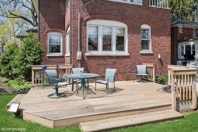 wooden deck featuring outdoor dining area