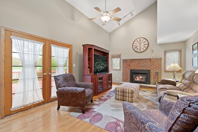 1065 Cedar Creek Dr, Lake Zurich, IL 60047 - living room featuring wood finished floors, high vaulted ceiling, ceiling fan, french doors, and a fireplace