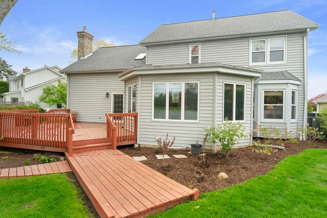 1065 Cedar Creek Dr, Lake Zurich, IL 60047 - rear view of property featuring a deck, a chimney, a yard, and a shingled roof