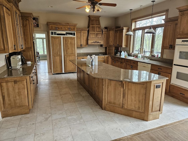 6554 N 16000e Rd, Grant Park, IL 60940 - kitchen with white appliances, a kitchen island, ceiling fan, and brown cabinetry