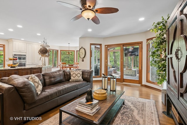 42W142 Ravine Dr, Saint Charles, IL 60175 - living area featuring healthy amount of natural light, a ceiling fan, light wood-style flooring, and recessed lighting