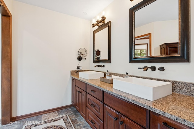 42W142 Ravine Dr, Saint Charles, IL 60175 - bathroom with baseboards, stone finish floors, and double vanity